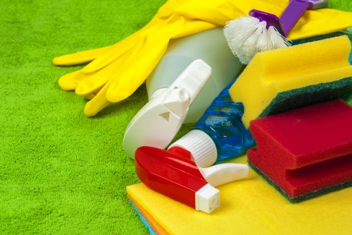 Technician wearing PPE while cleaning carpet in a residential room